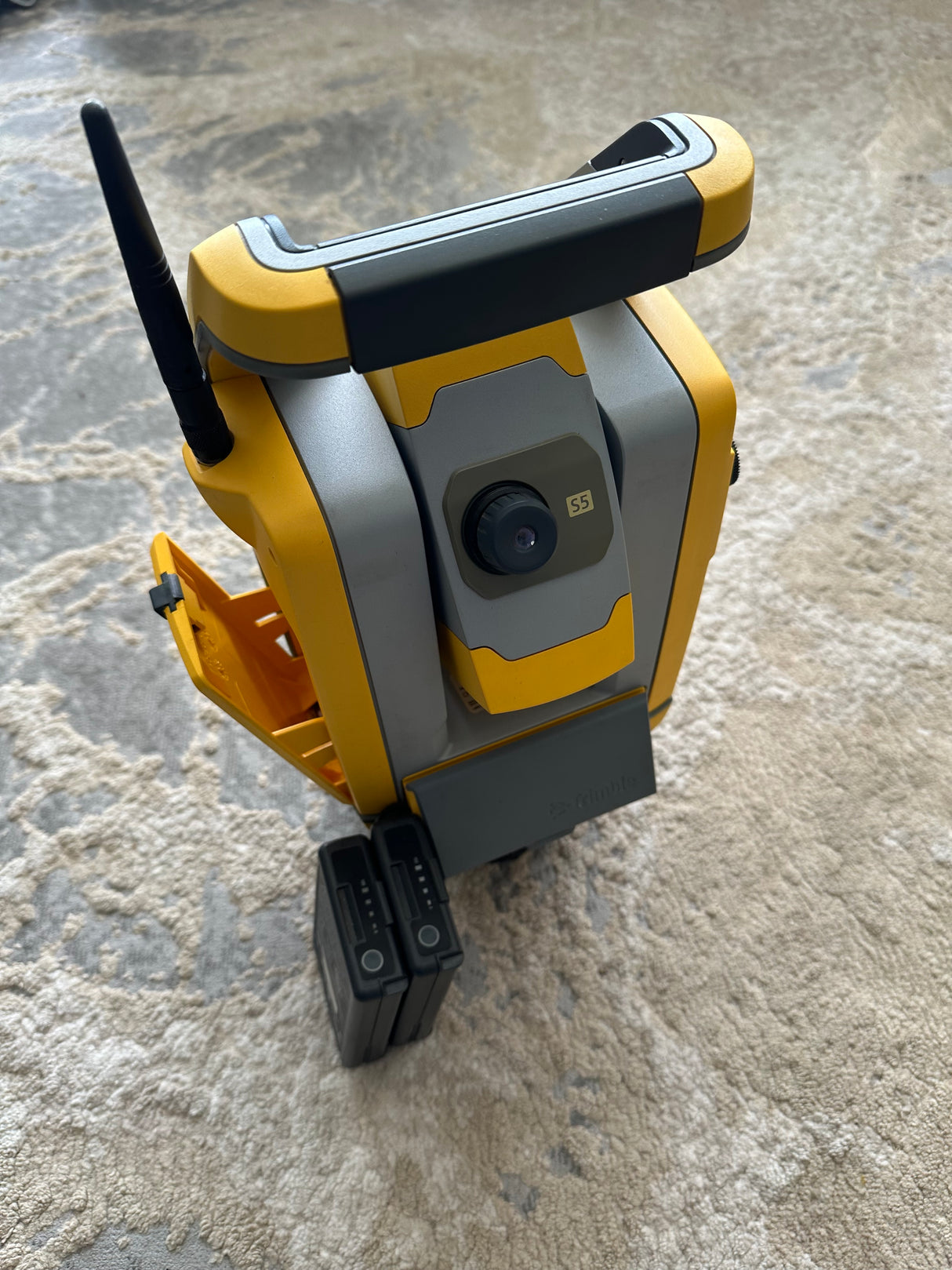 Side view of Trimble S5 robotic total station with carbon pole