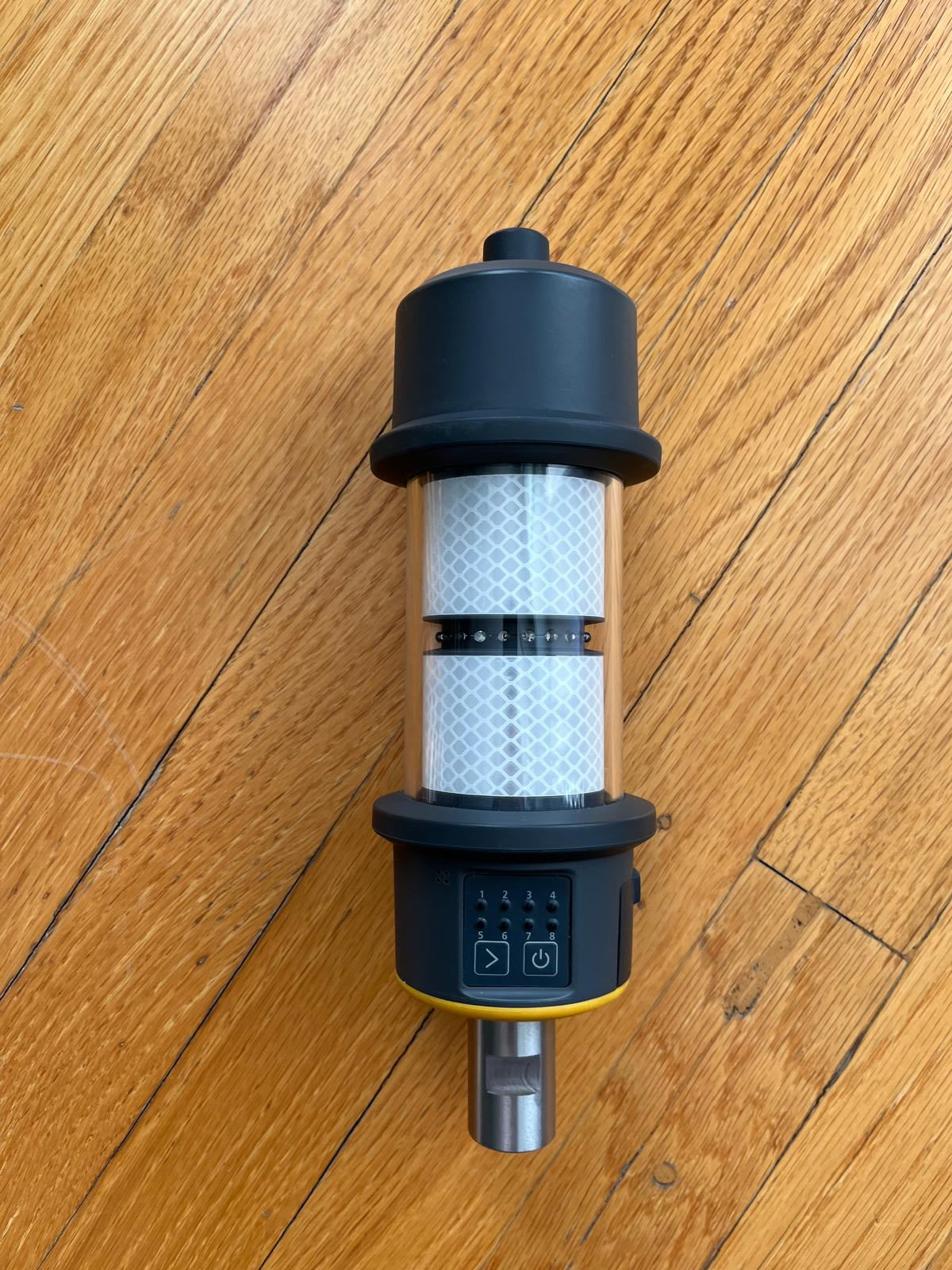 Front view of used Trimble AT360 prism with included battery